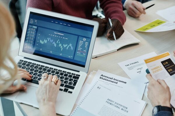 woman typing on computer showing graphs