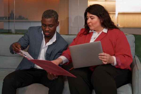 woman and man reviewing documentation together on a couch