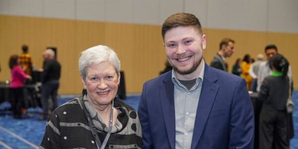 A man and woman standing together at an event