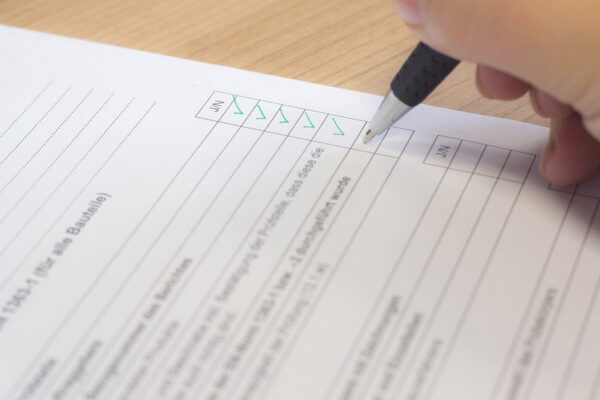 survey being filled out with a green pen