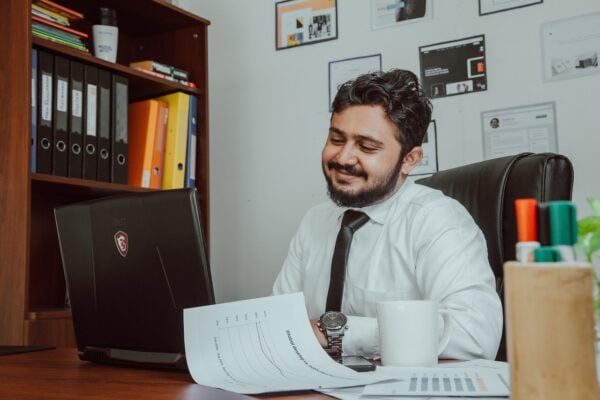 man sitting behind desk