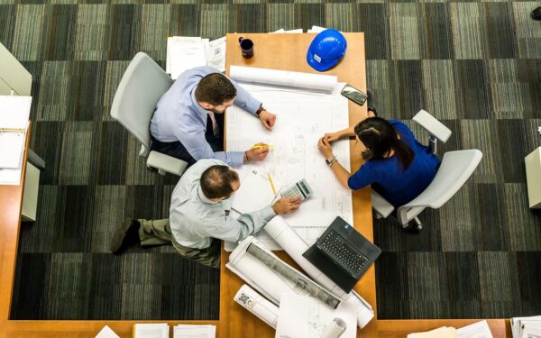 three people working around a table