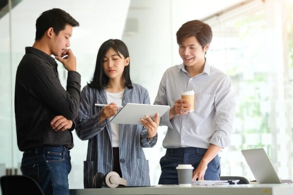 three coworkers standing next to each other