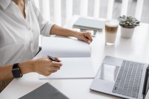 side view businesswoman workin with notebook and laptop