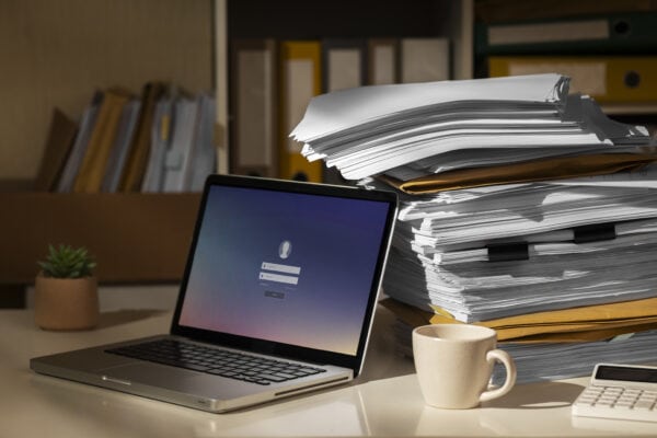 stack of documents and laptop
