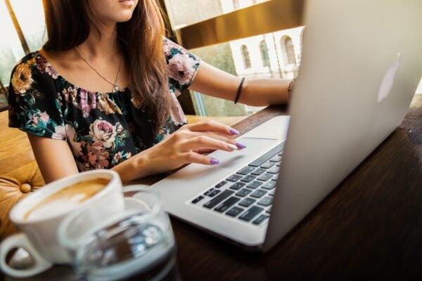 young woman typing on laptop