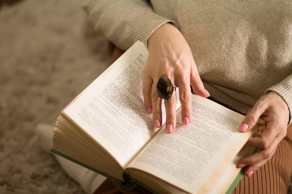 woman wearing a ring reading a book