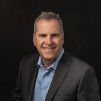 Professional photo of Steve Hunt wearing a blue shirt and dark jacket.