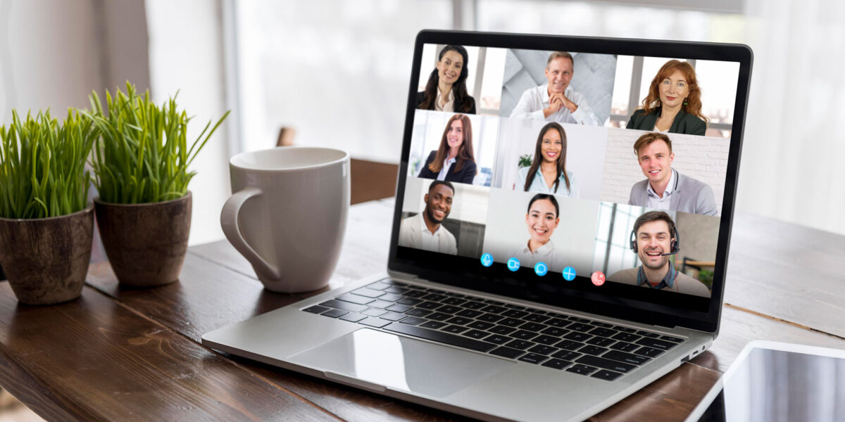 A laptop screen featuring a video call, with 9 individuals