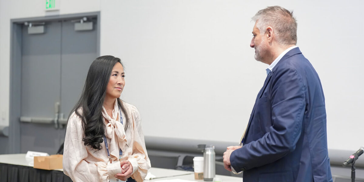 A man and woman engaged in conversation at a table
