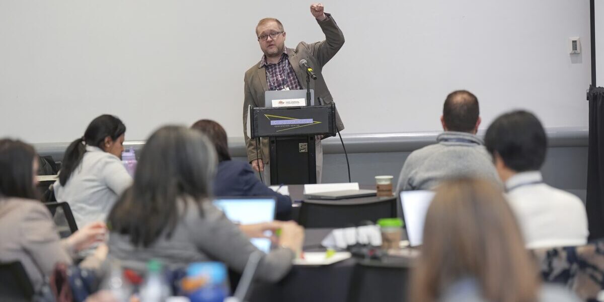 A man giving a presentation to a group of people.