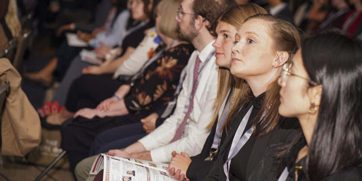 Attendees listening at a professional conference.