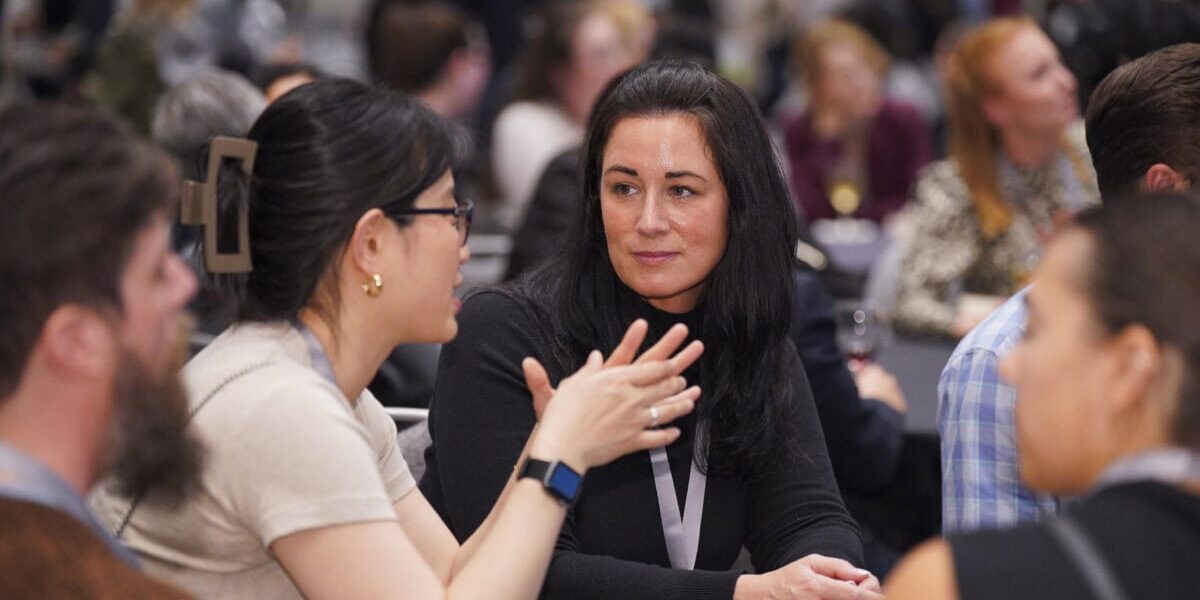 Industrial-organizational psychologists engaging in discussion at a professional event.