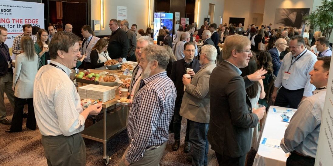 People networking at I/O psychology conference.