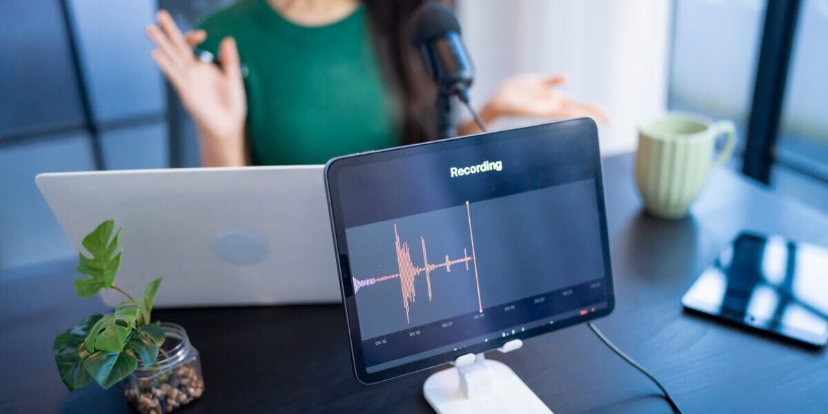Woman making audio podcast in studio