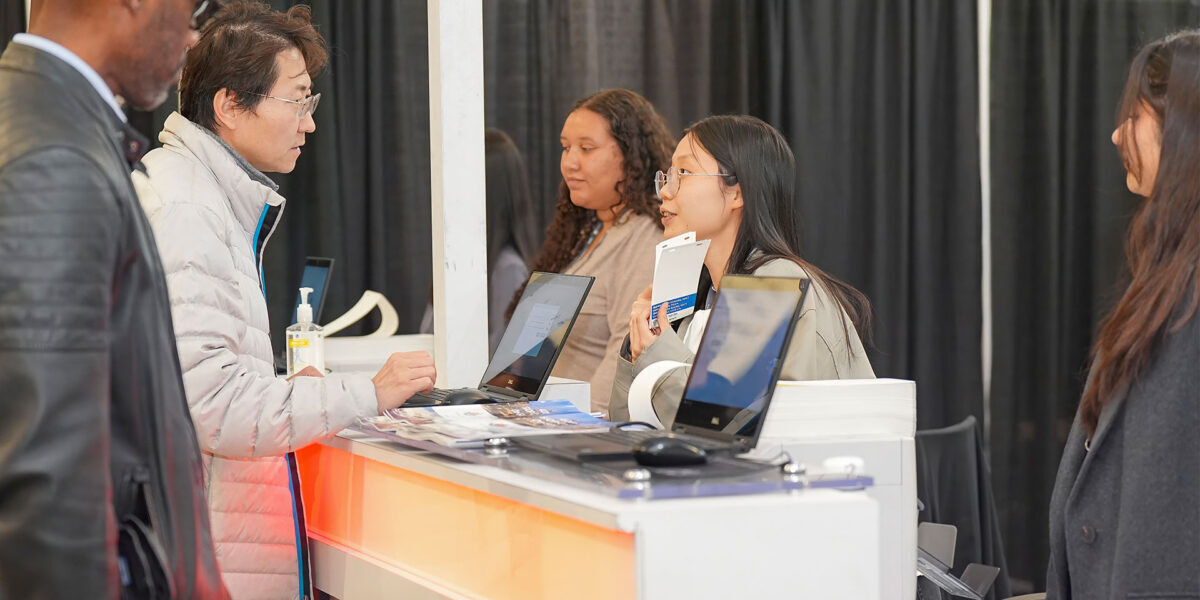 A group of people gathered around a table, engaged in conversation at a formal event.