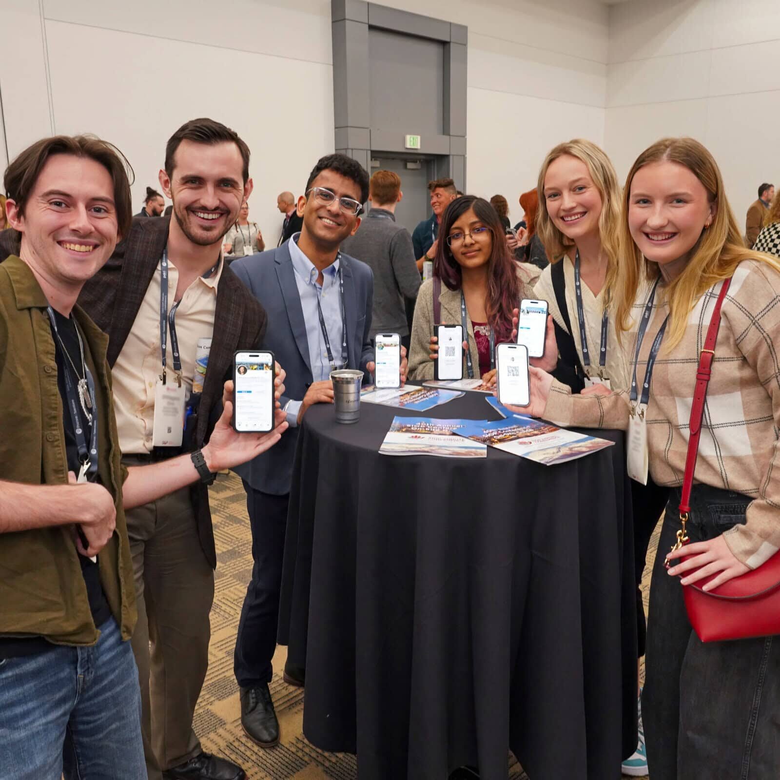 A diverse group of people smiling and posing together for a photo at one of SIOP's annual conferences.