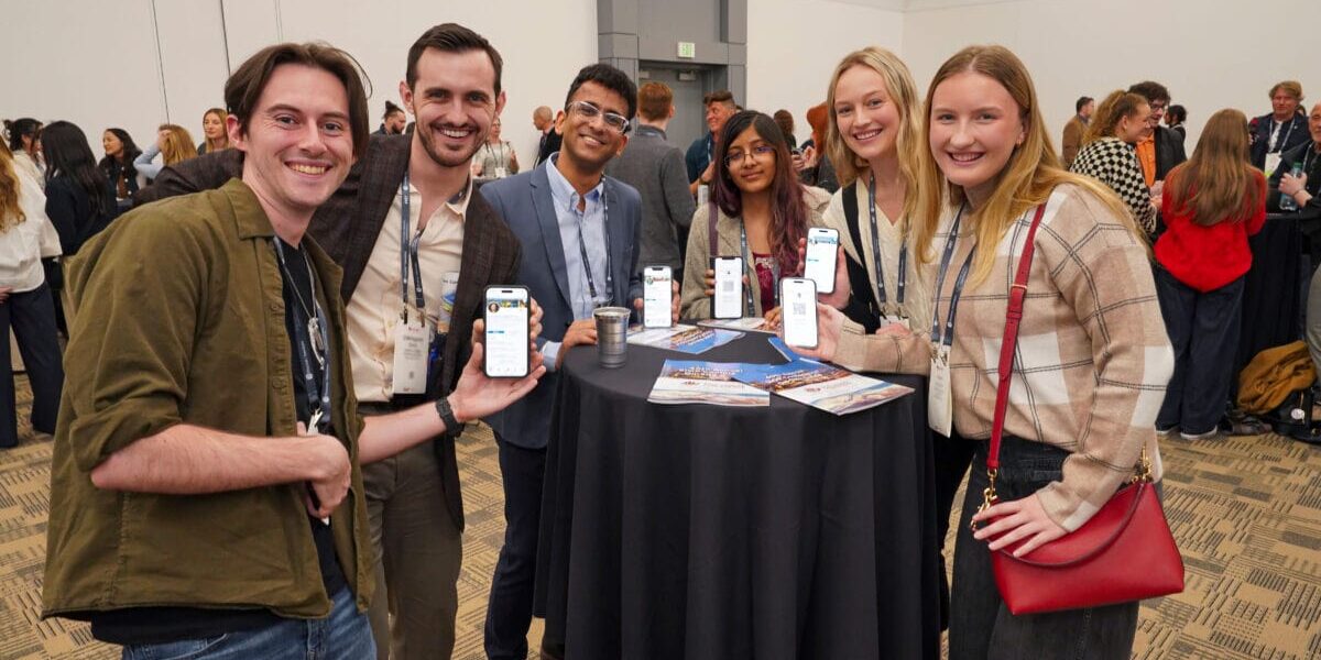 A cheerful group of individuals gathered together, posing for a photo at a social event.