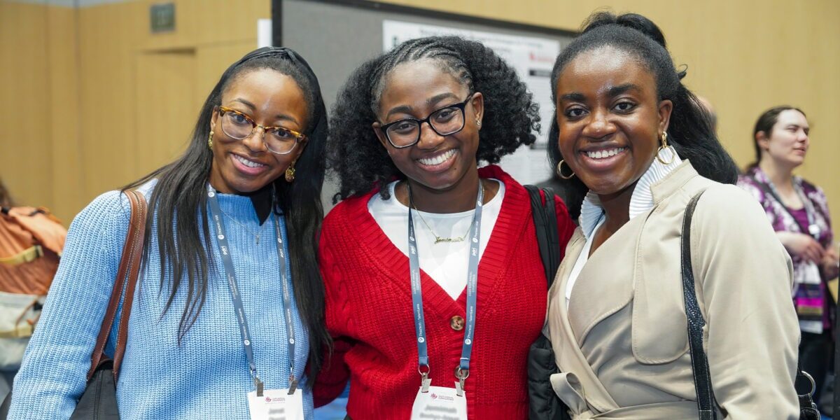 Three women smiling at the camera at the 2025 SIOP Annual Conference.