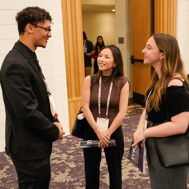 Group of professionals engaging in conversation at a SIOP Annual Conference event.