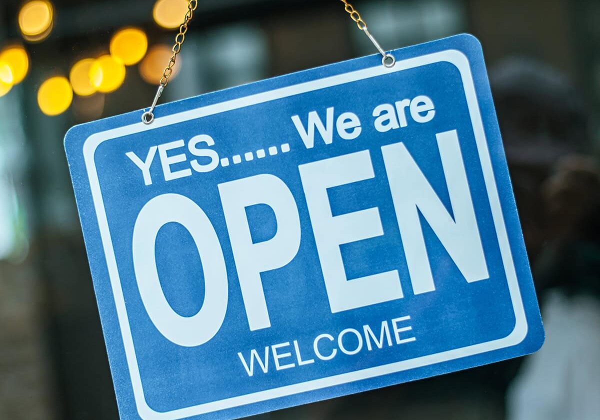 open sign broad through the glass of window at coffee shop
