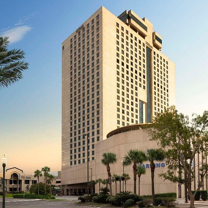 hilton-new-orleans-riverside Exterior view of the Hilton New Orleans Riverside Hotel in New Orleans, LA