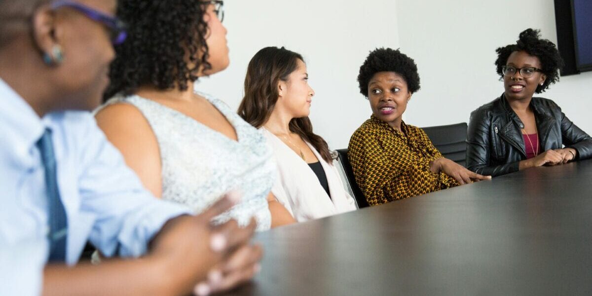 A group of professional talking around a conference table.