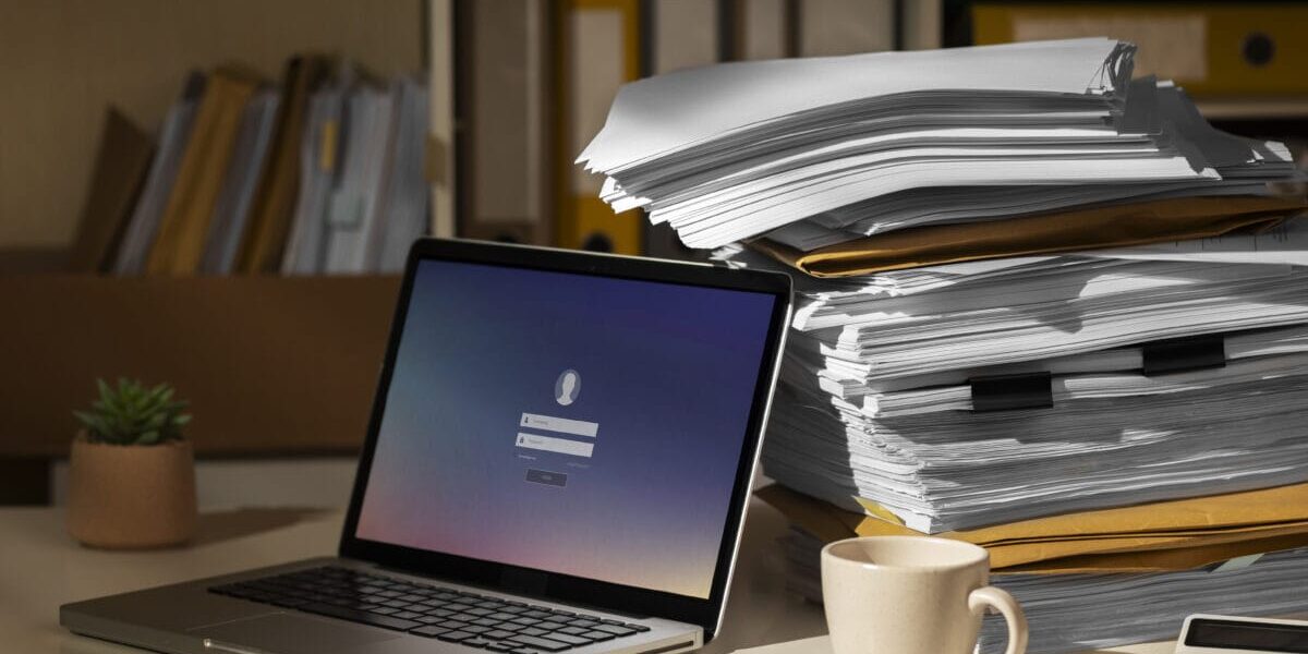 stack of documents and laptop